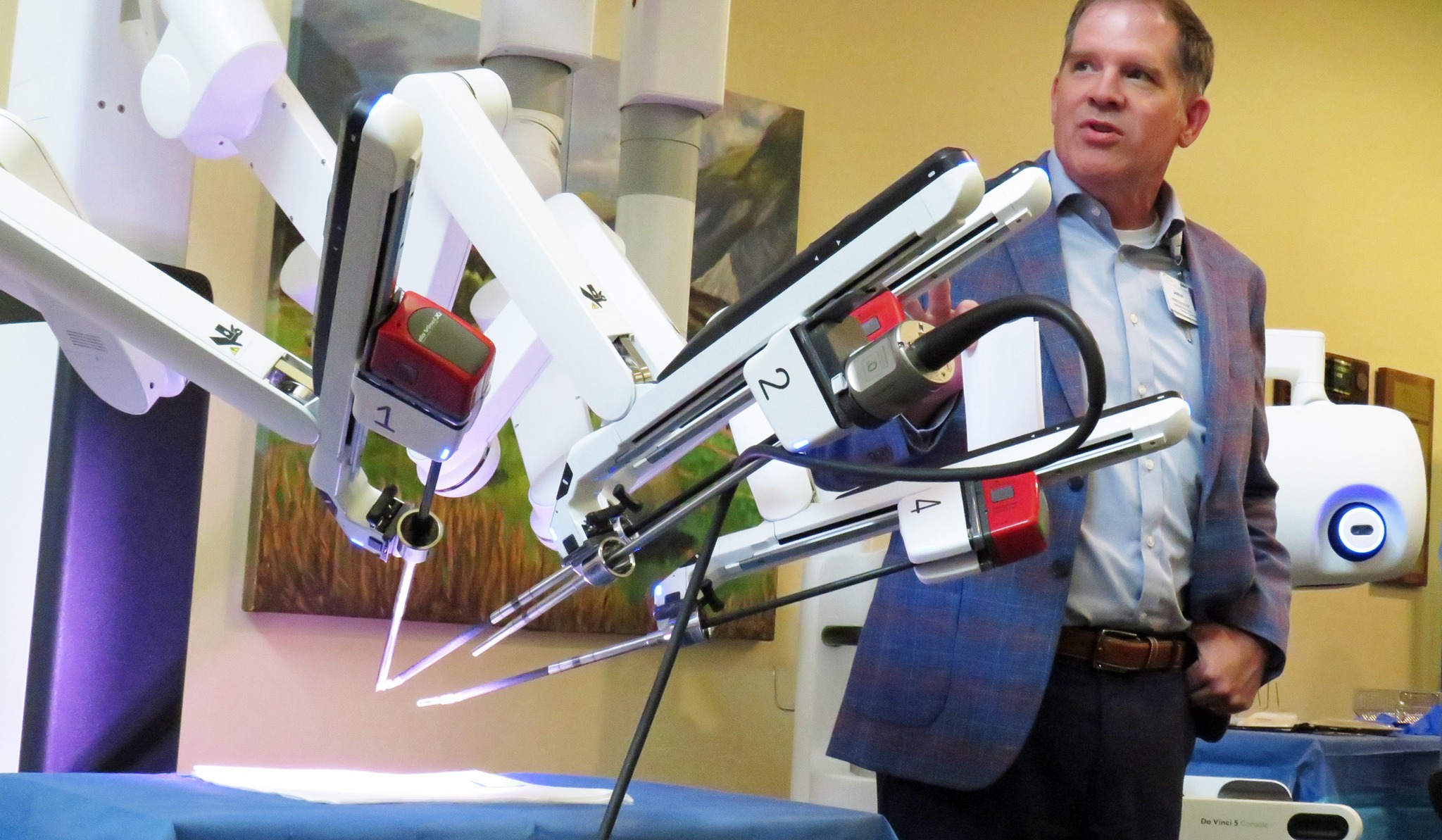 Person standing in front of robotic surgery machine