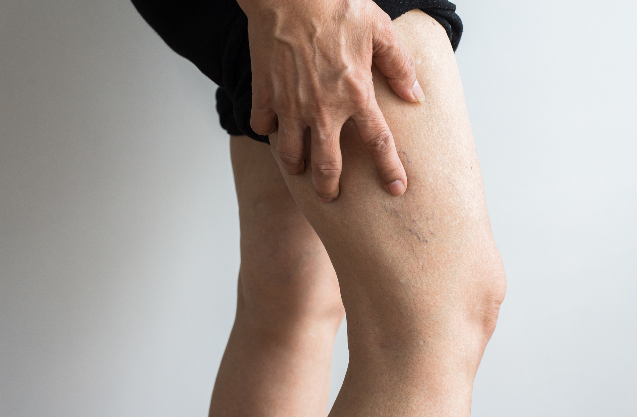 Person holding their leg