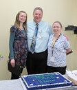 3 people and a cake