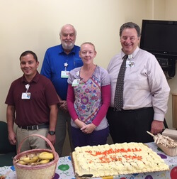 4 people with a cake