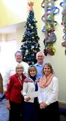 Pearson-Sawyer and her team in front of a Christmas tree
